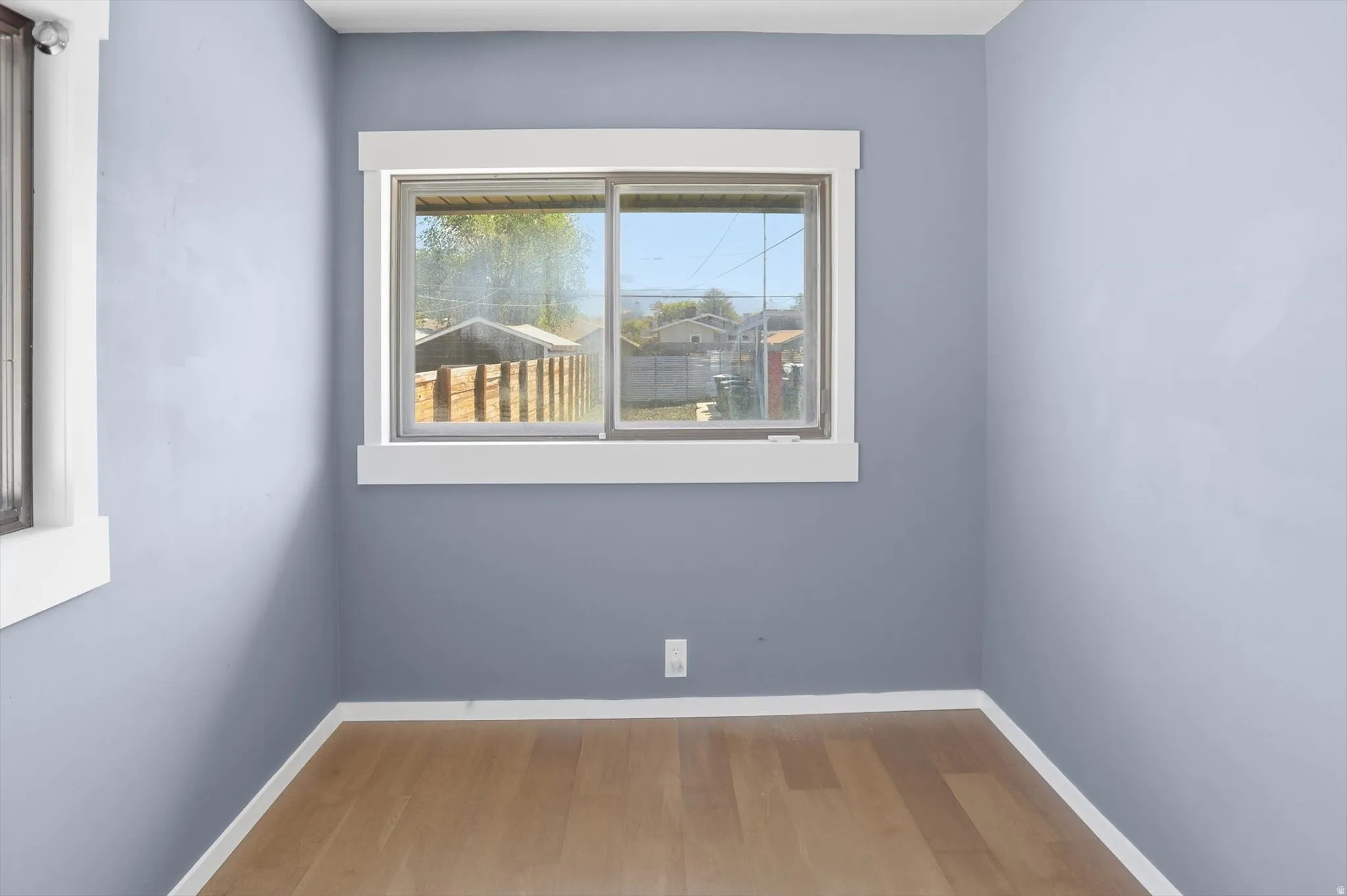 Spare room with light wood-type flooring and baseboards