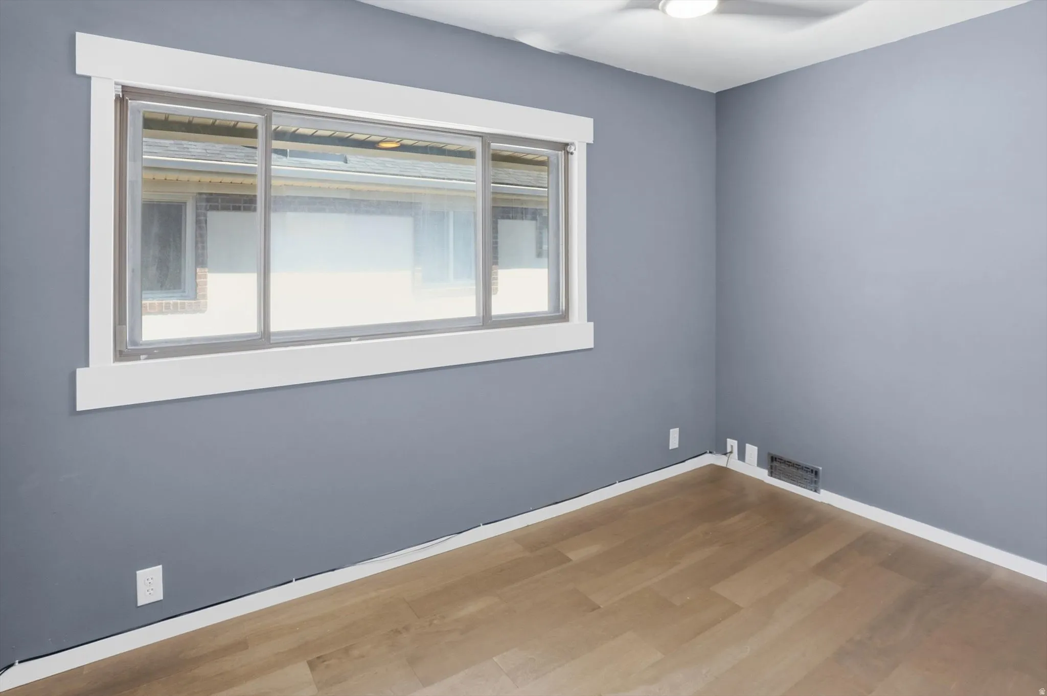 Unfurnished room featuring light wood-style flooring and baseboards