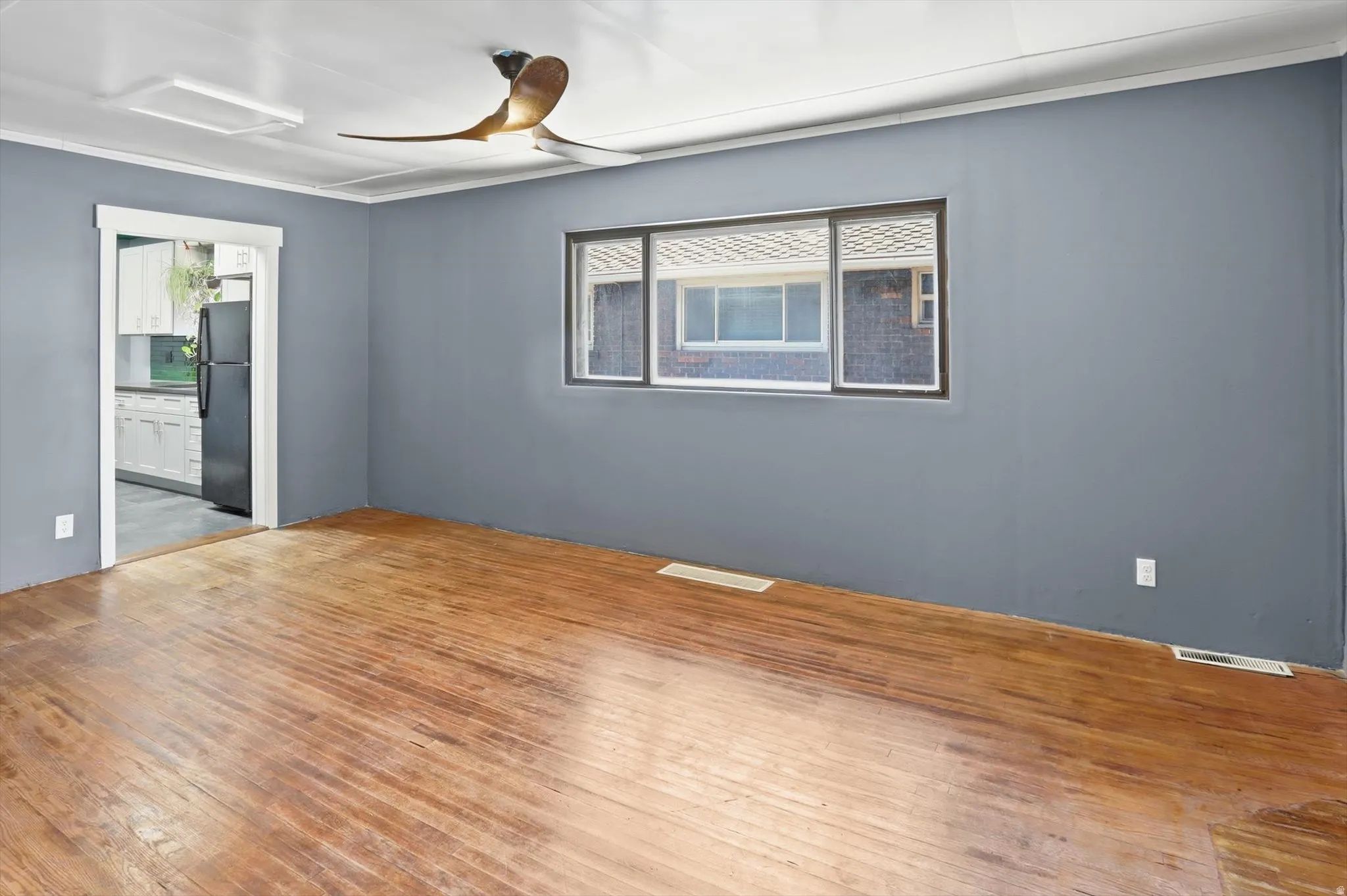 Unfurnished room featuring ceiling fan and wood-type flooring