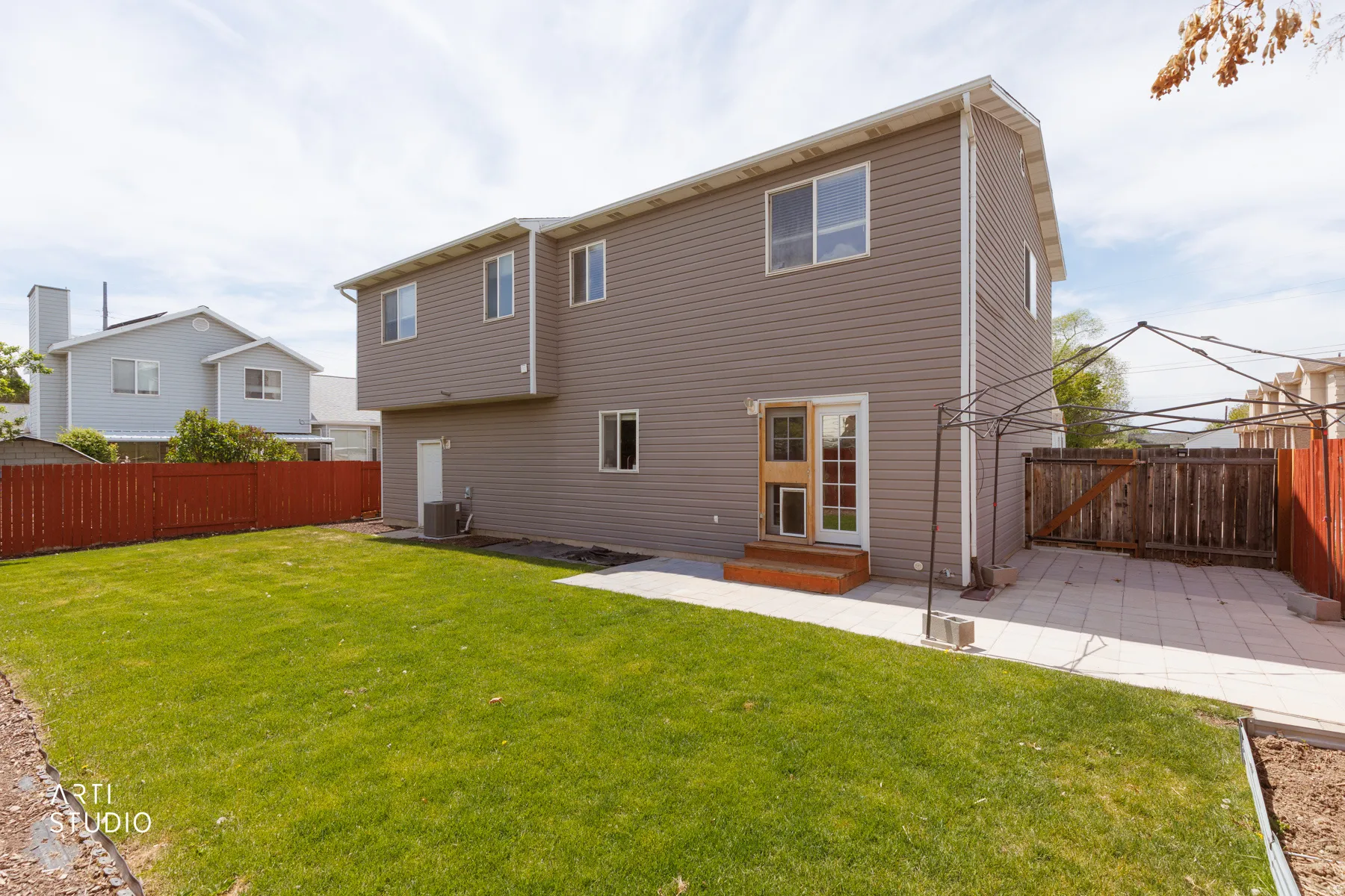 Back of house featuring a patio, a fenced backyard, a gate, and entry steps