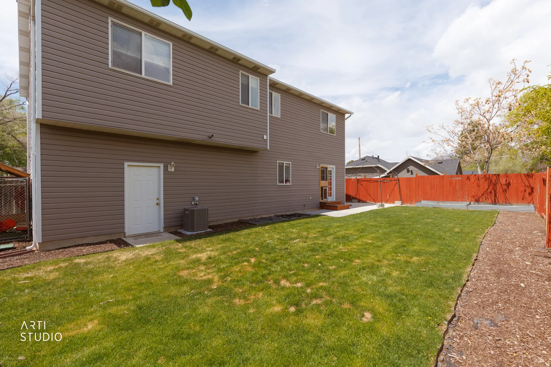Back of property with a fenced backyard