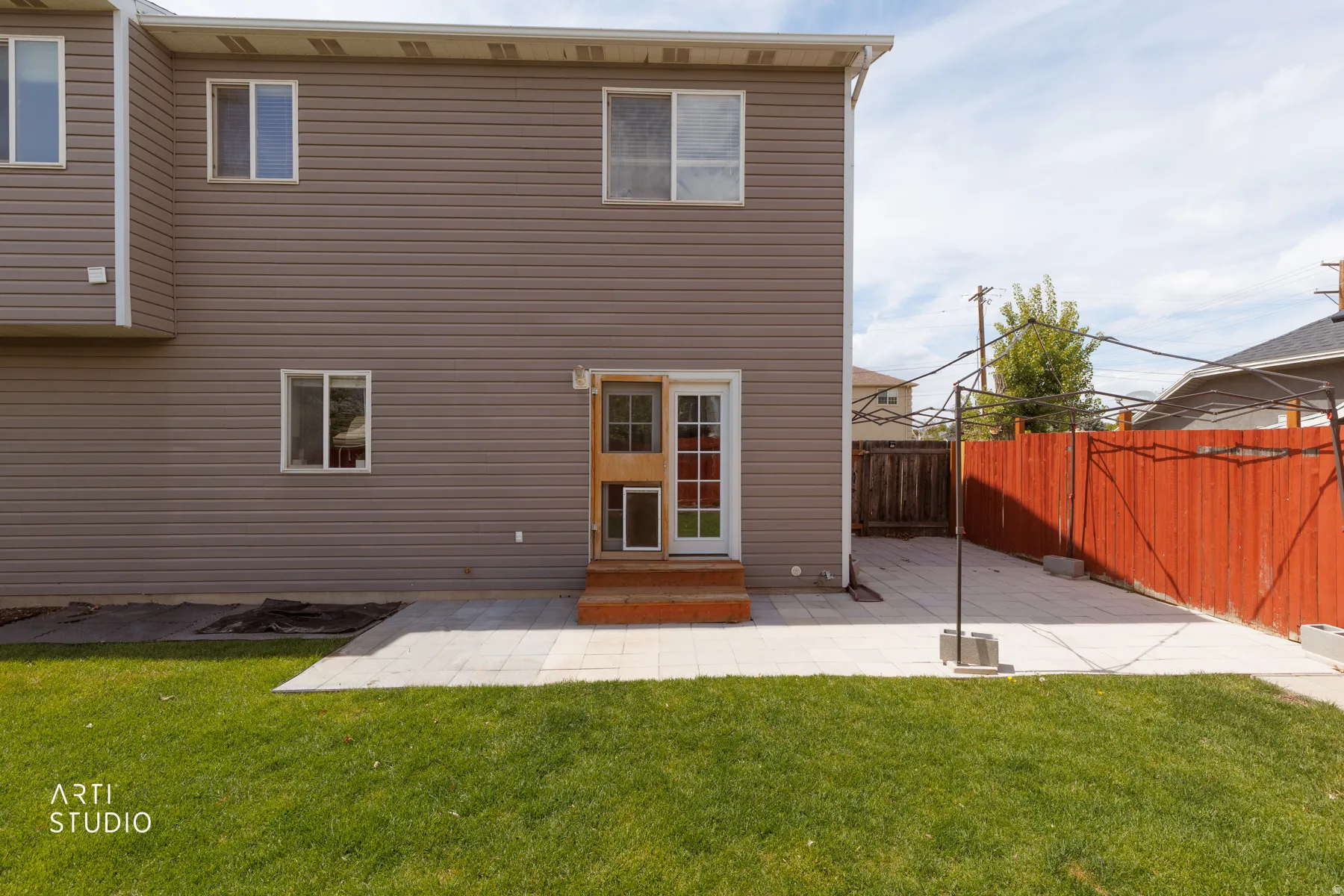 Back of house with a patio and a fenced backyard