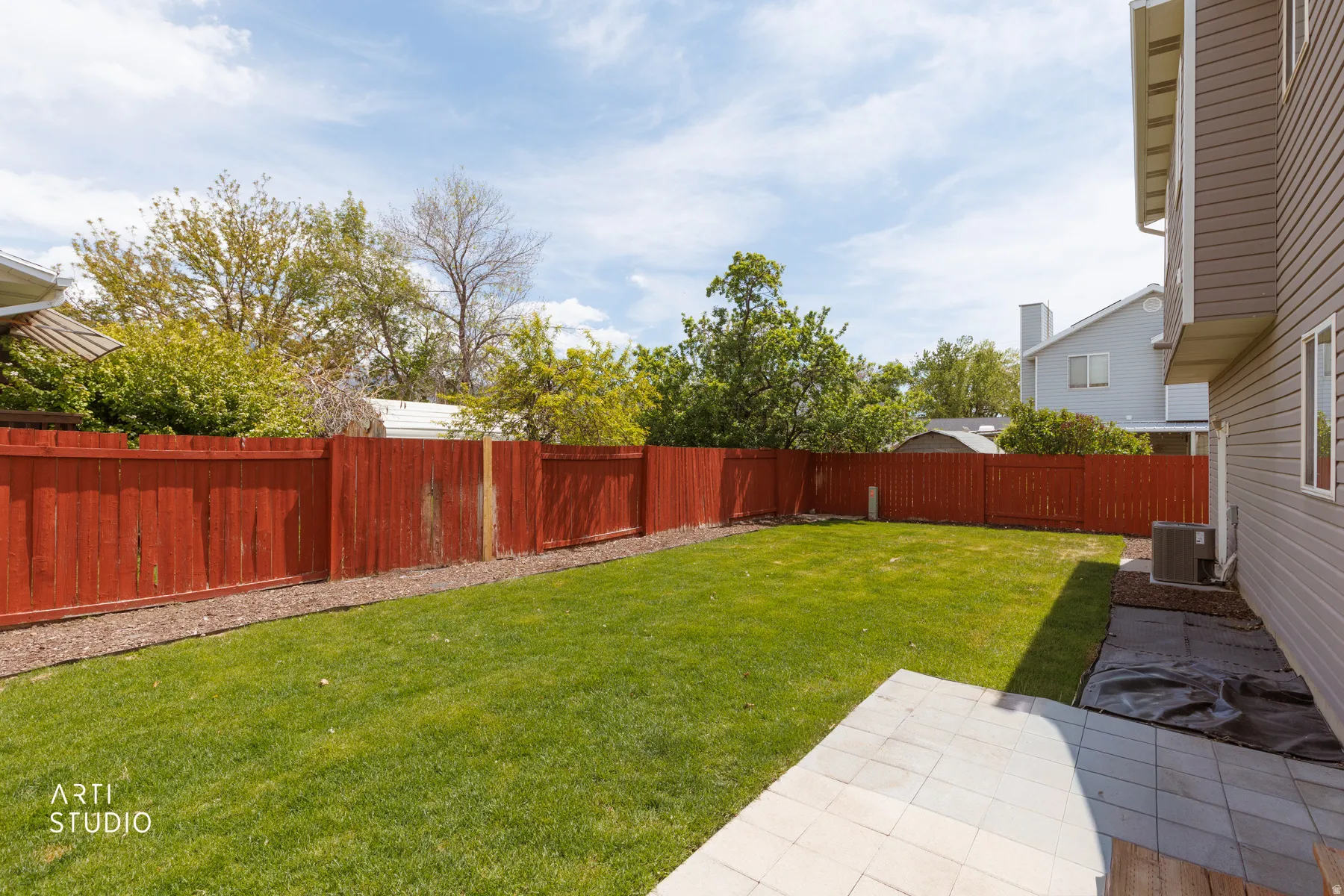 Fenced backyard featuring a patio