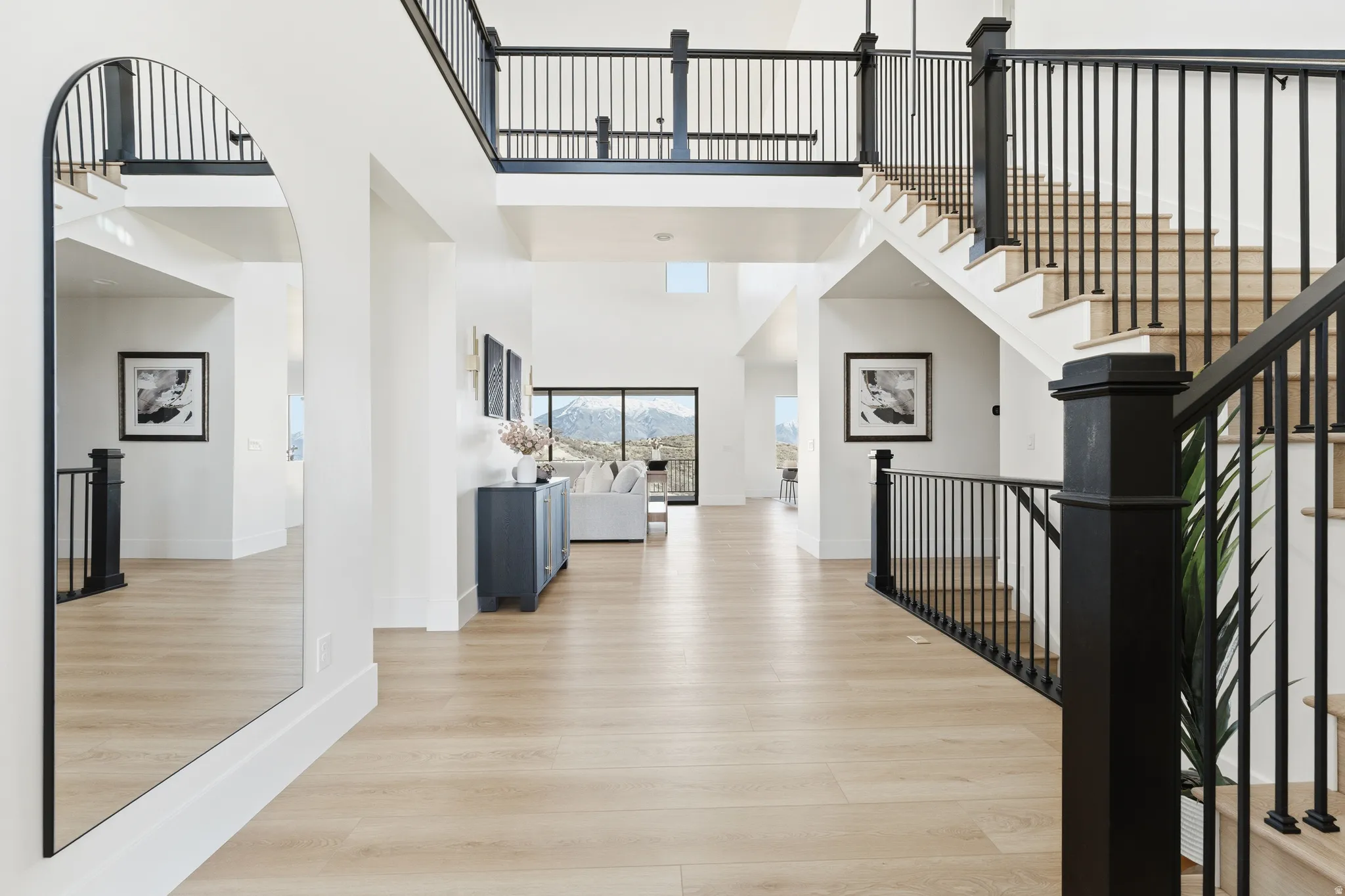Entryway with light wood-type flooring and a high ceiling