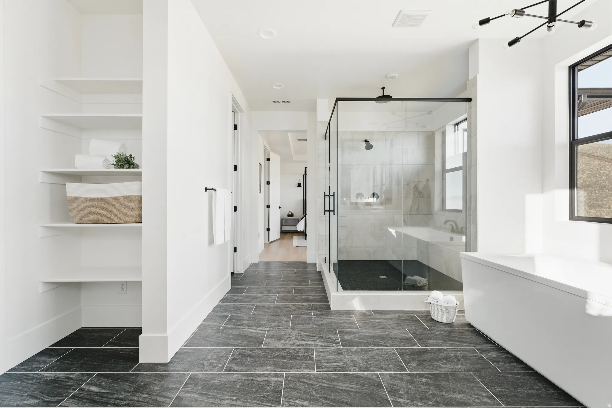 Full bathroom with a stall shower and built in shelves