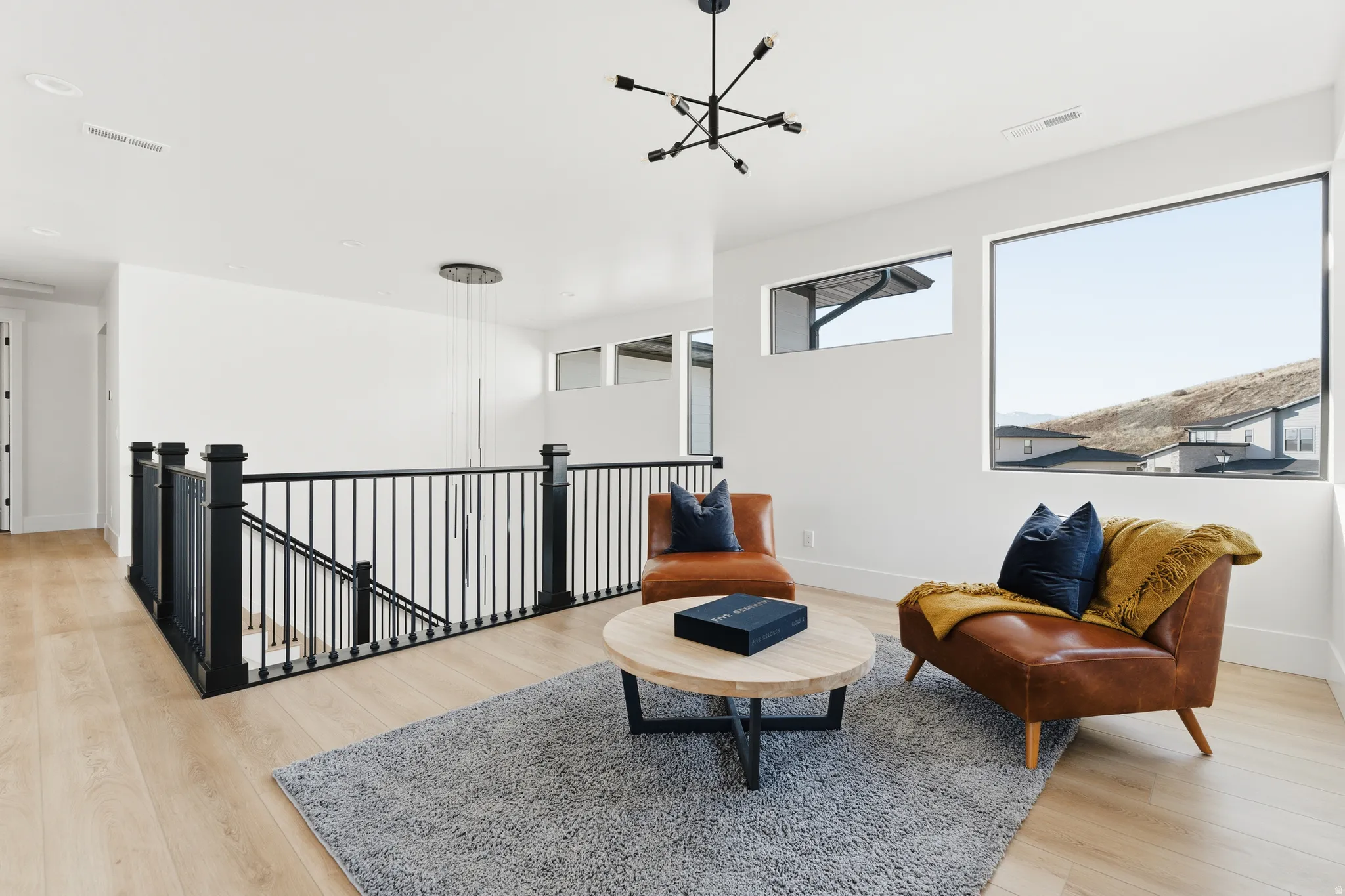 Living area featuring an upstairs landing and light wood-type flooring