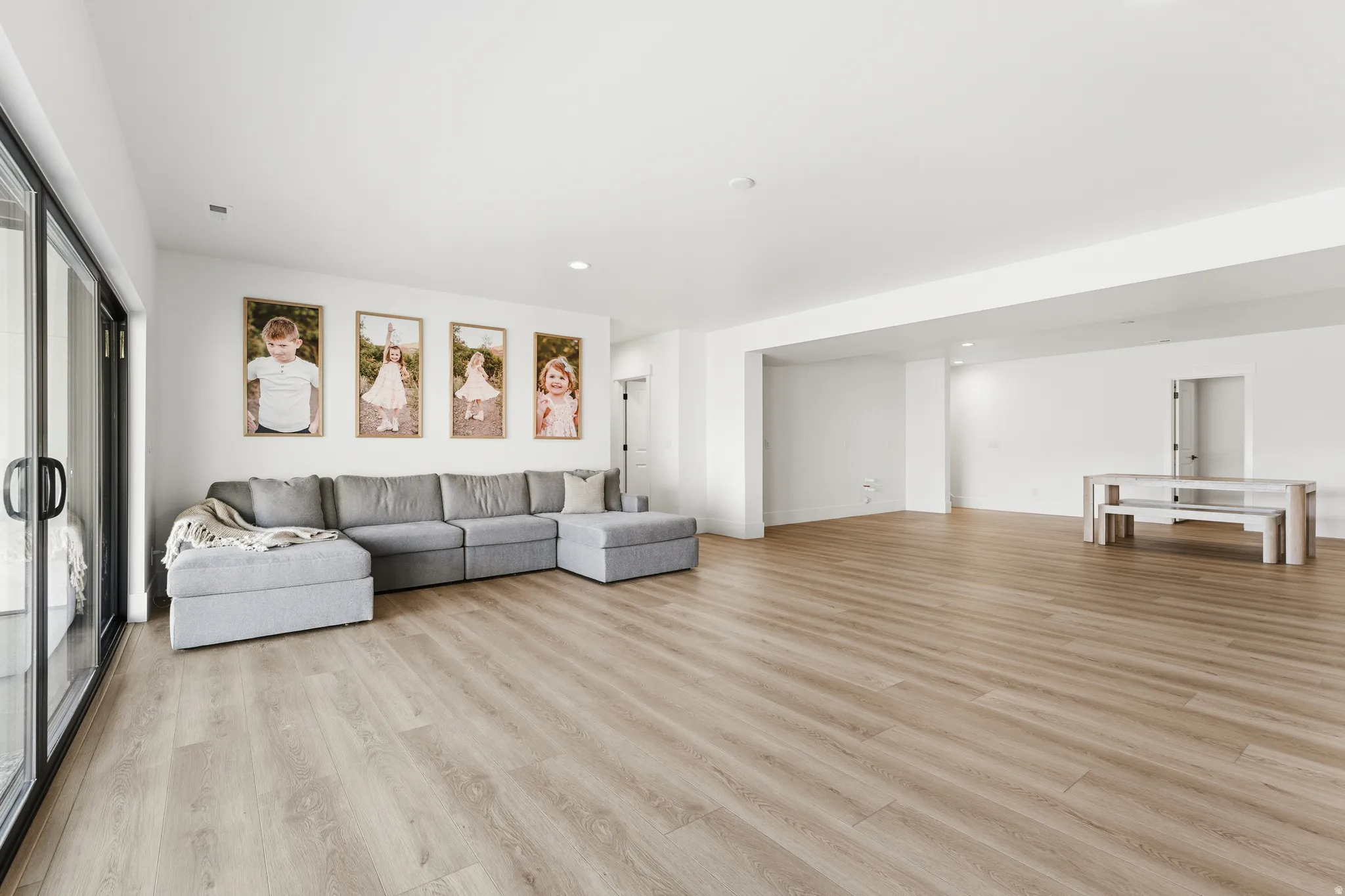 Living room featuring light wood-type flooring and recessed lighting