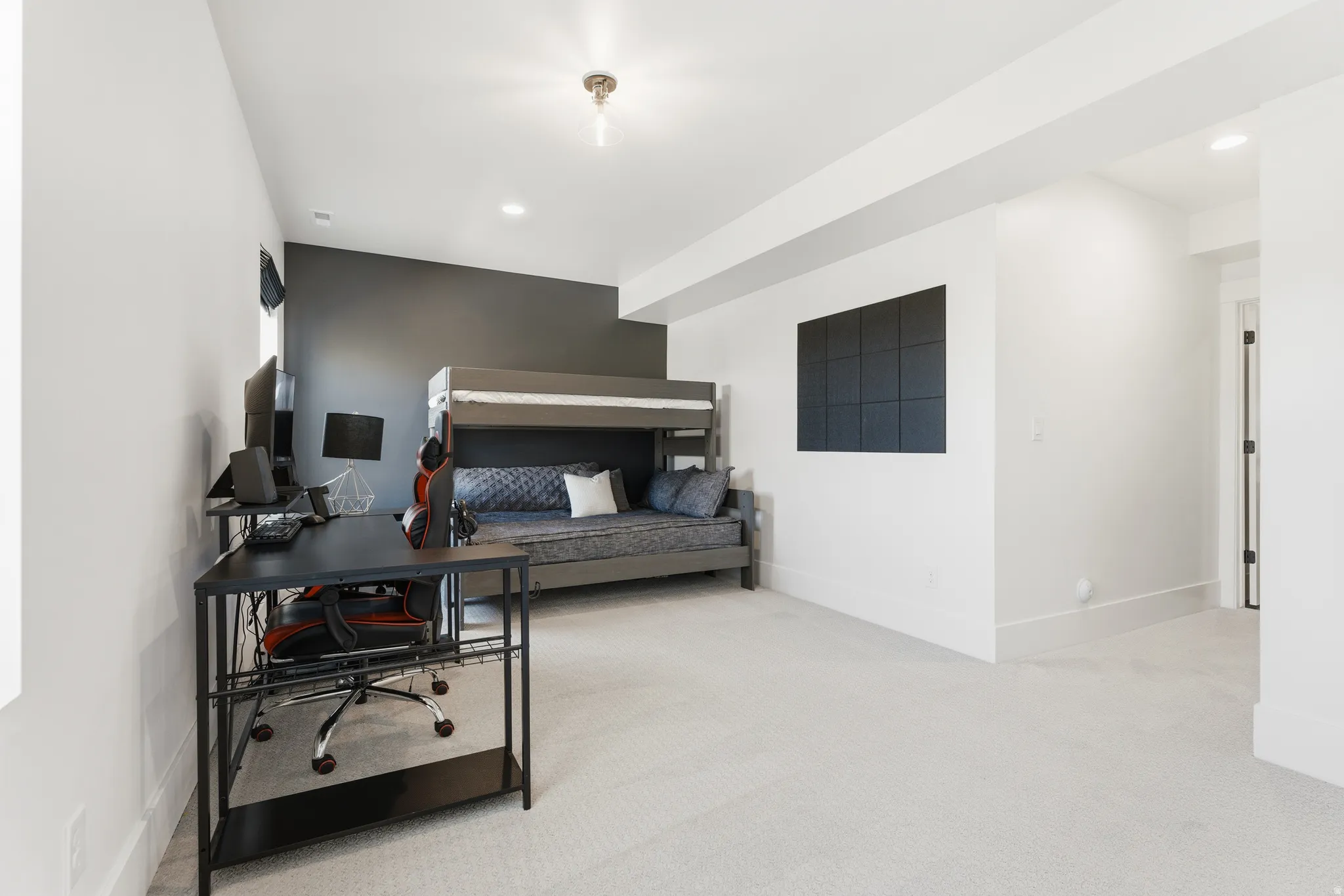 Bedroom with light colored carpet, a desk, and recessed lighting