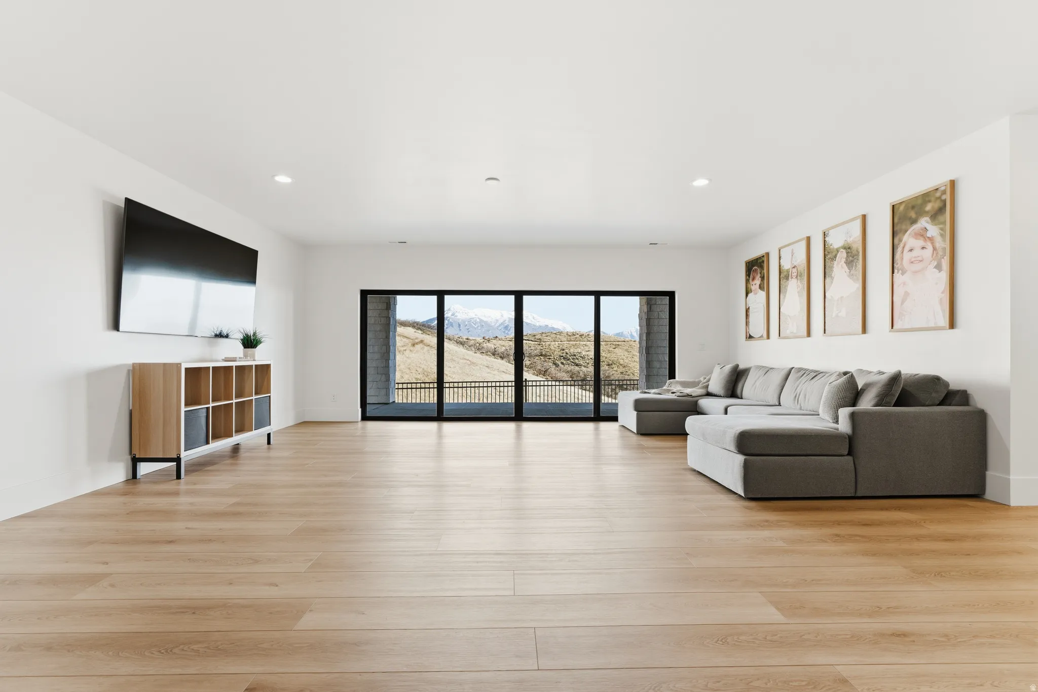 Living area featuring light wood-style floors and recessed lighting