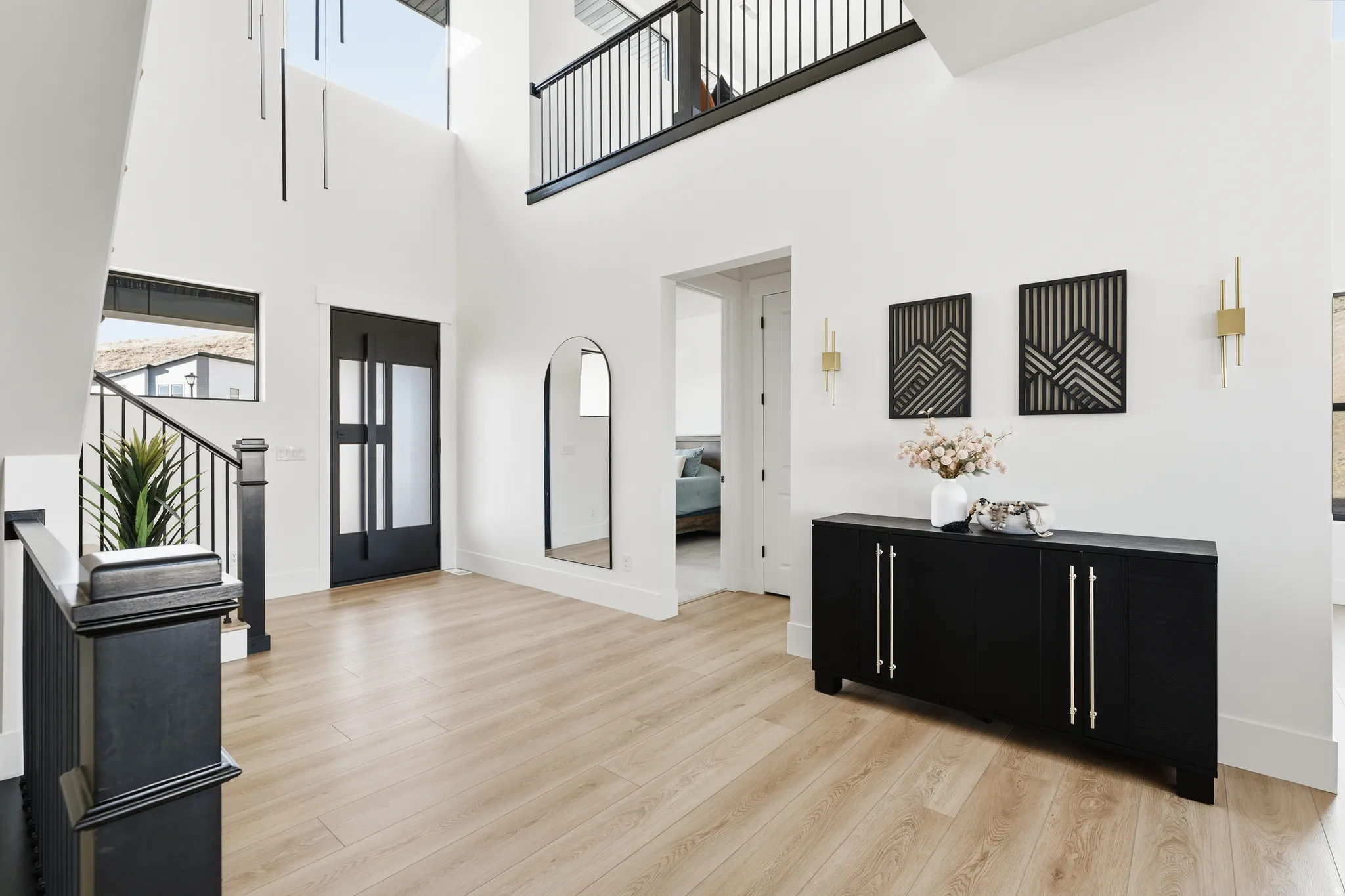 Entrance foyer featuring light wood-style floors and a high ceiling