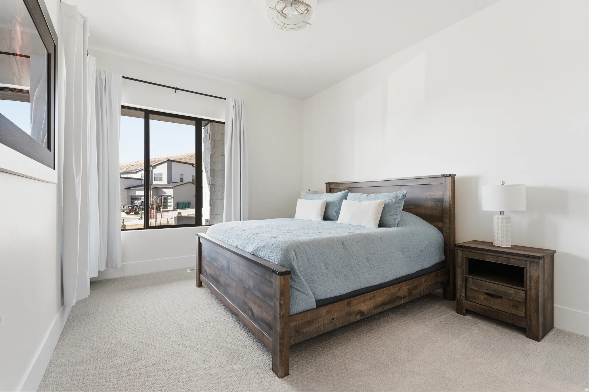 Bedroom with light carpet and baseboards