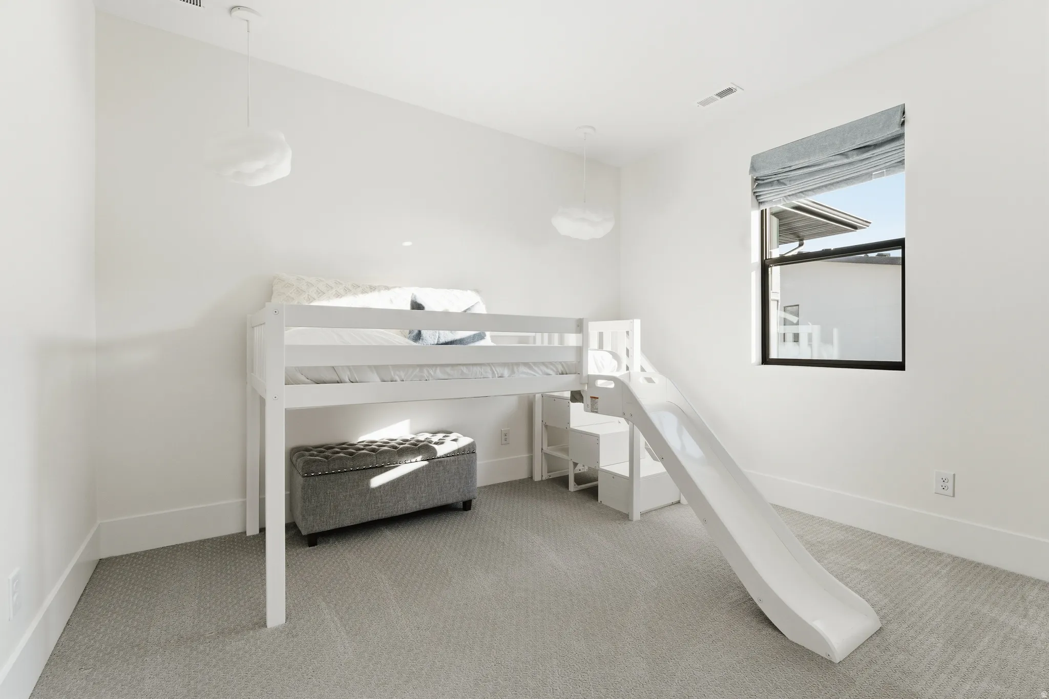 Bedroom featuring light colored carpet