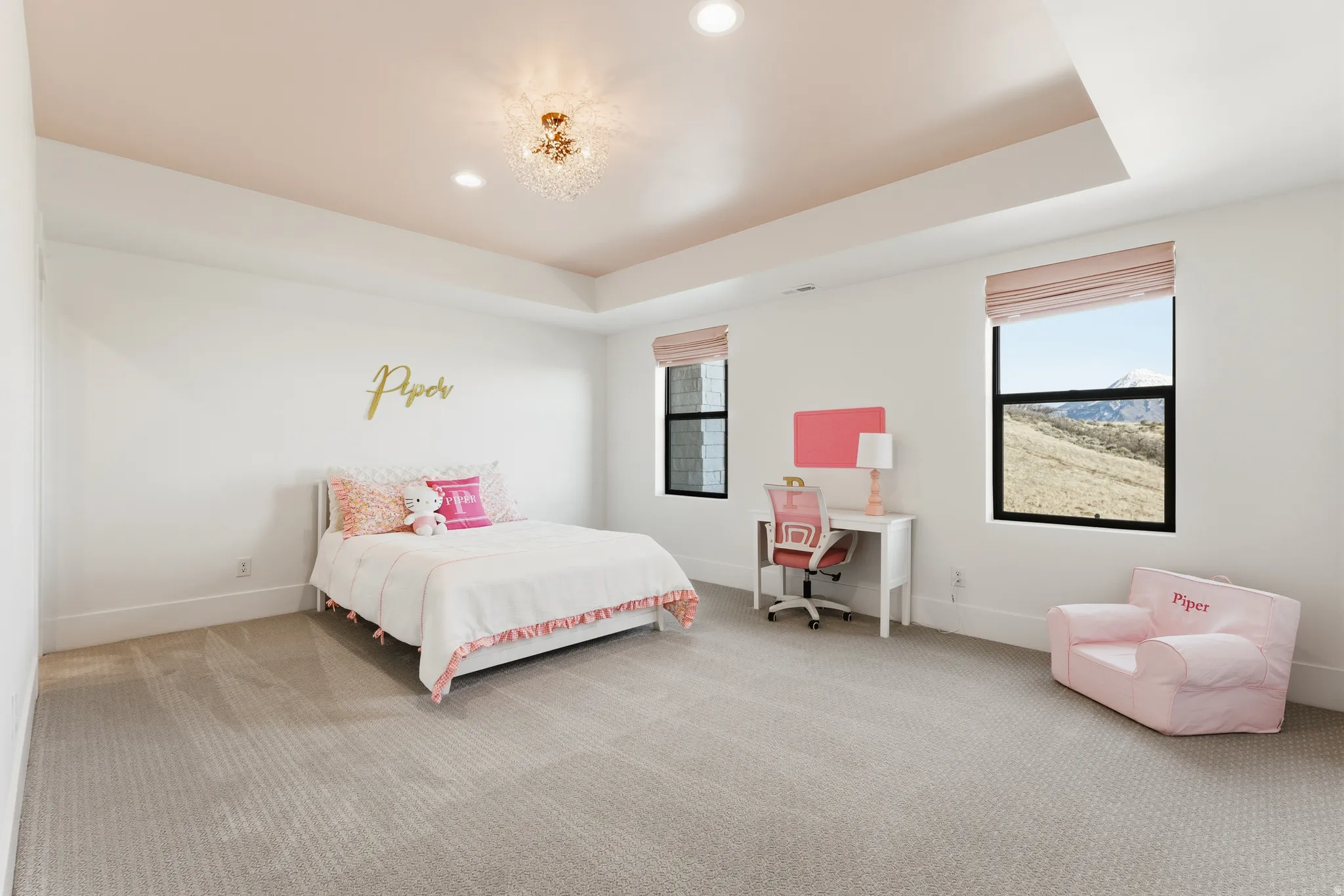 Bedroom with multiple windows, a raised ceiling, light colored carpet, and recessed lighting