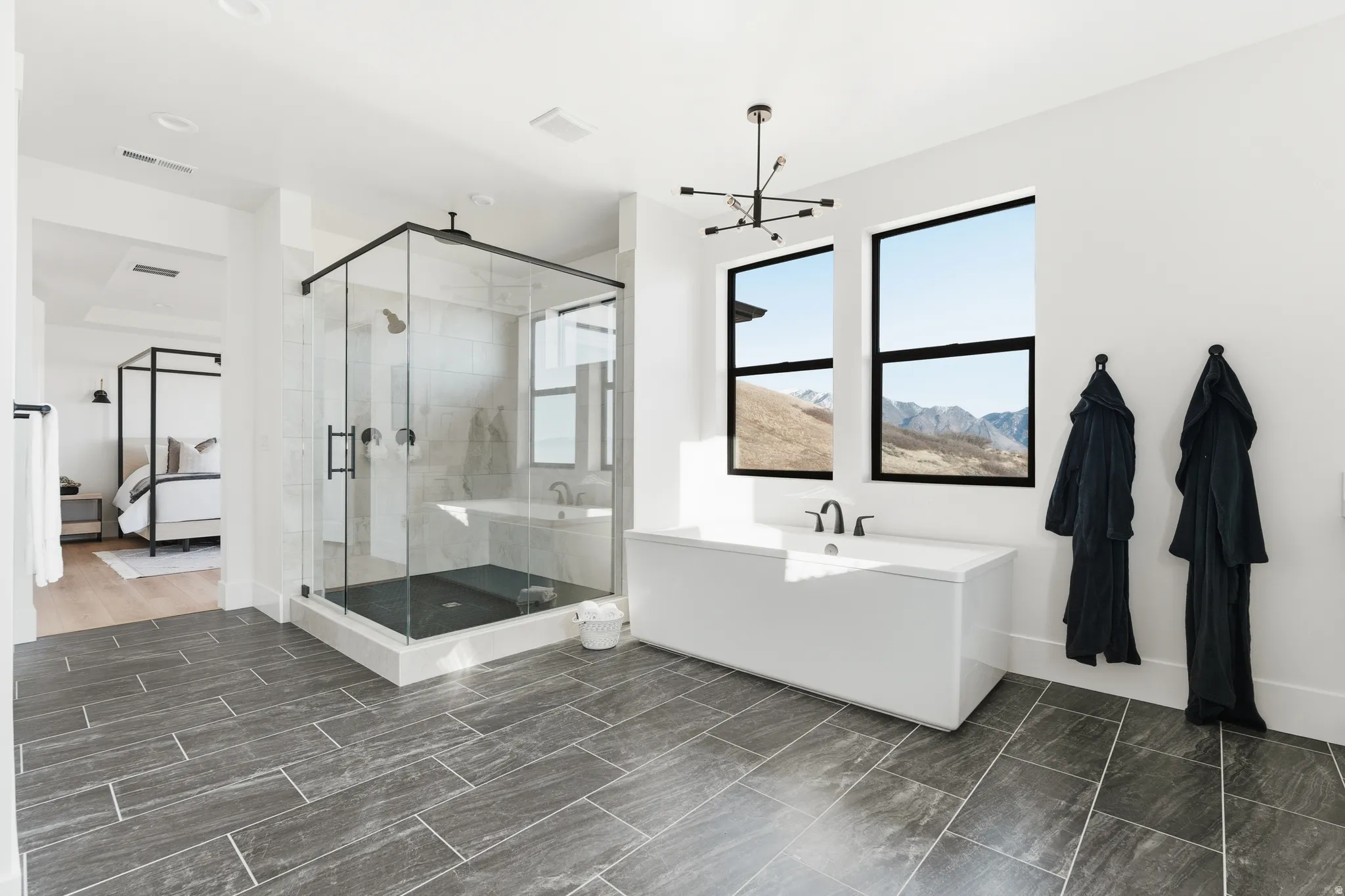 Ensuite bathroom featuring a shower stall and a tub