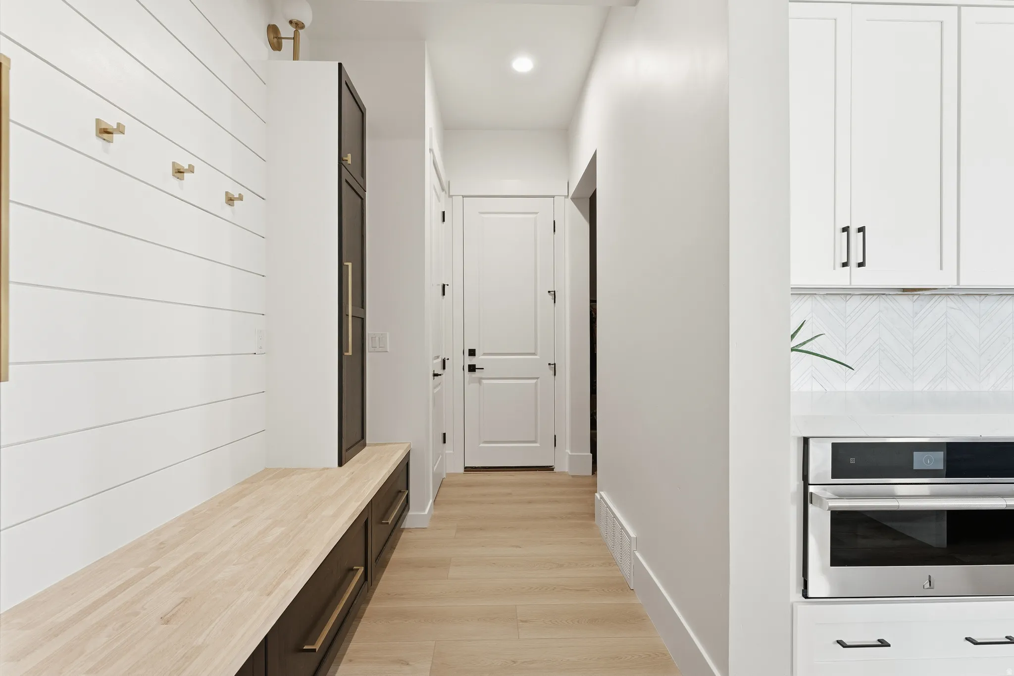 Mudroom with light wood-style flooring and recessed lighting