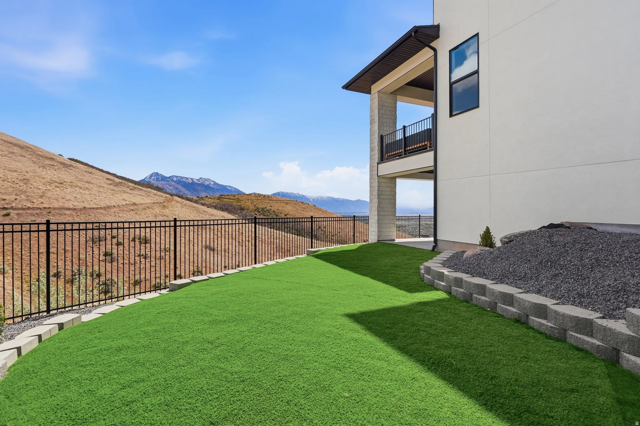 View of yard with a mountain view and a balcony