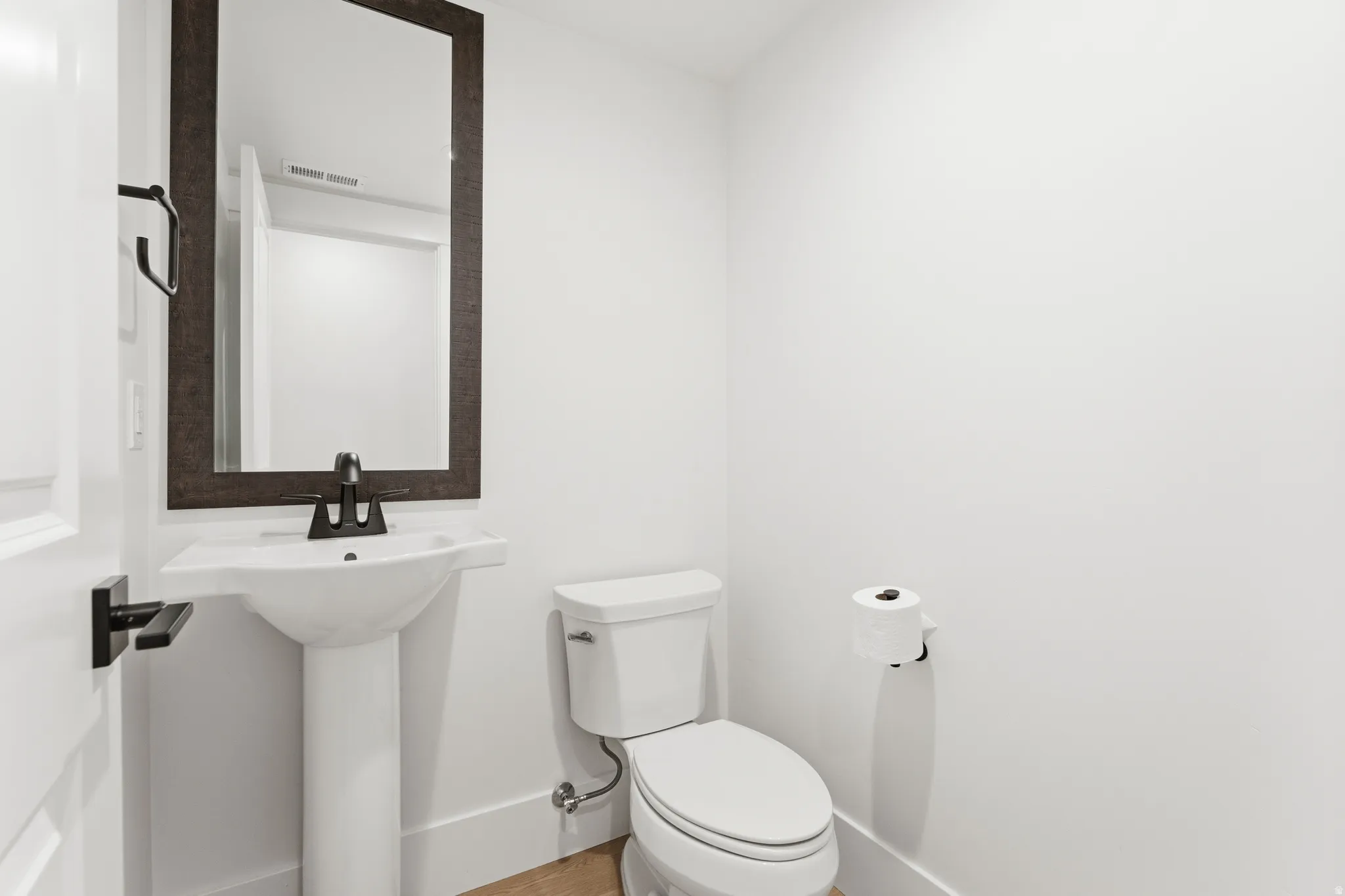 Bathroom with toilet and baseboards