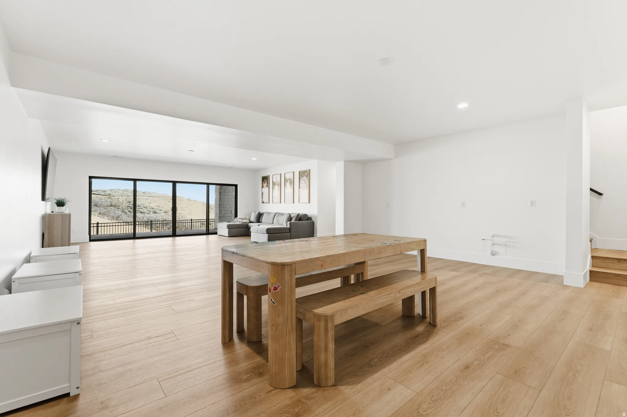 Dining area with light wood-type flooring and recessed lighting