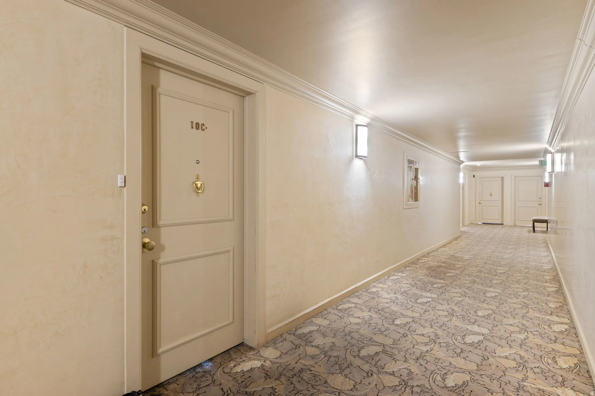 Corridor featuring crown molding and baseboards
