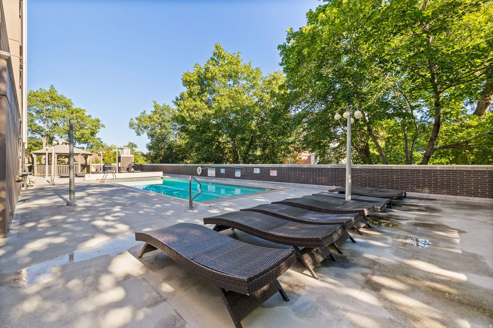 Community pool featuring a patio and a gazebo