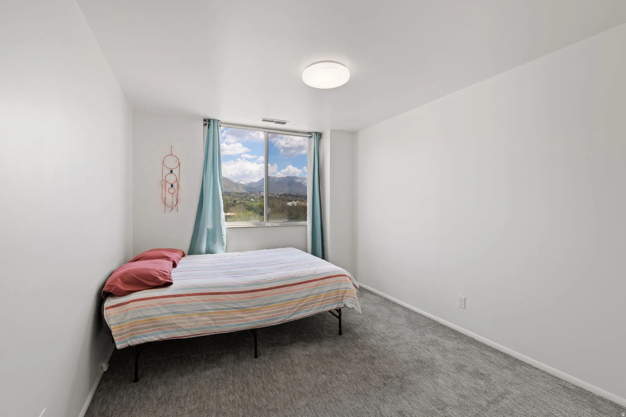 Bedroom featuring carpet flooring and a mountain view