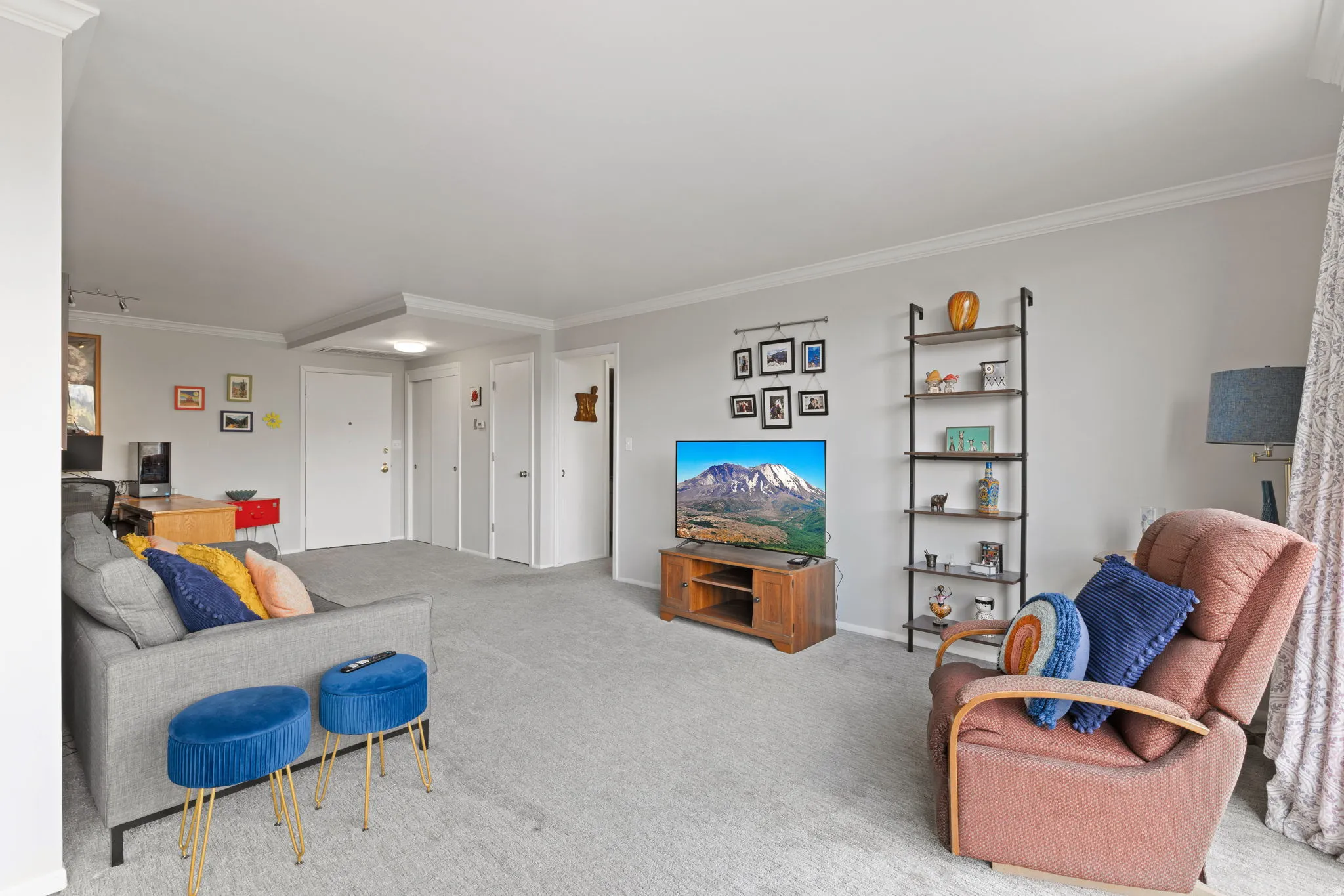 Living room featuring crown molding and light colored carpet