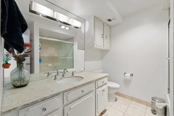 Bathroom featuring vanity, a shower stall, and light tile patterned floors