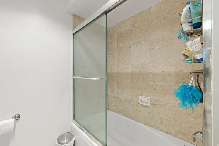 Bathroom featuring enclosed tub / shower combo
