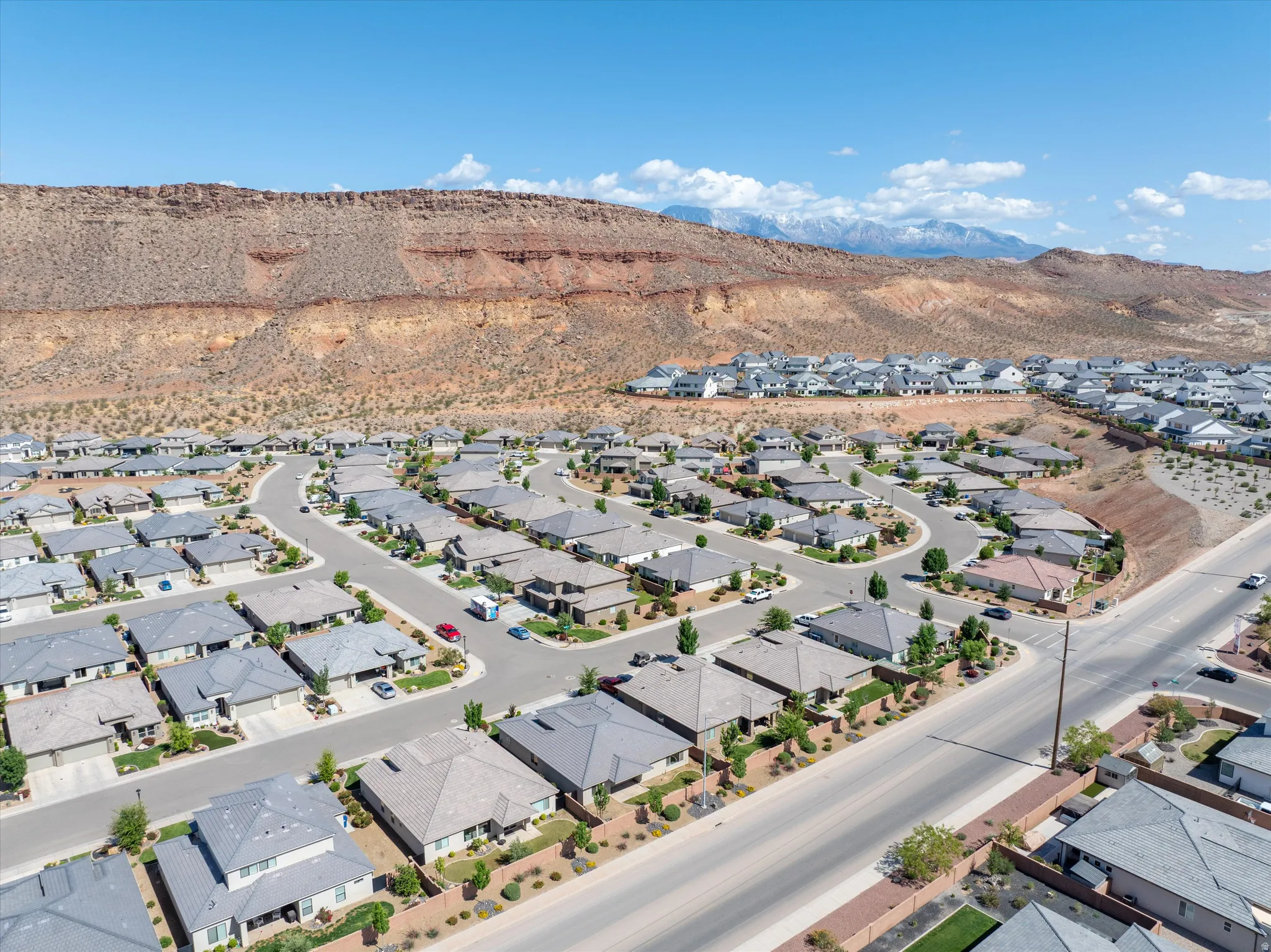Aerial perspective of suburban area with a mountain backdrop