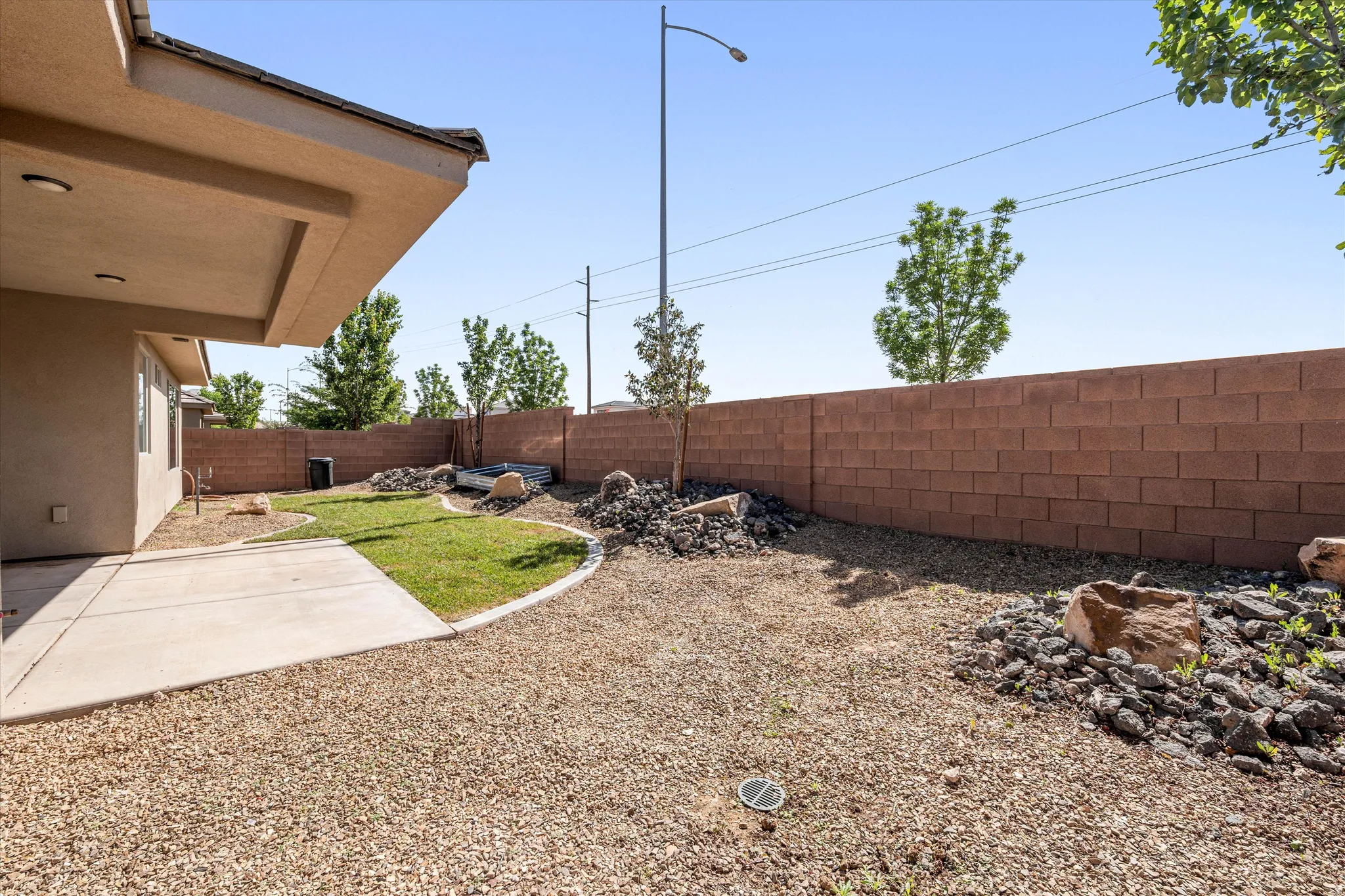Fenced backyard with a patio area