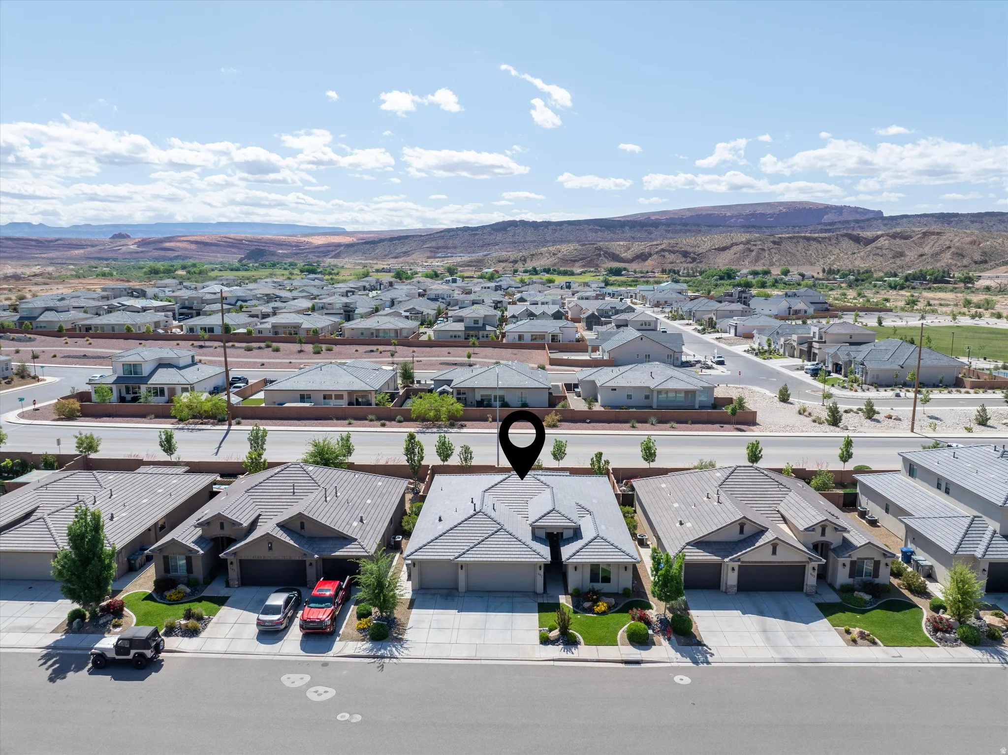 Aerial view of residential area featuring a mountainous background