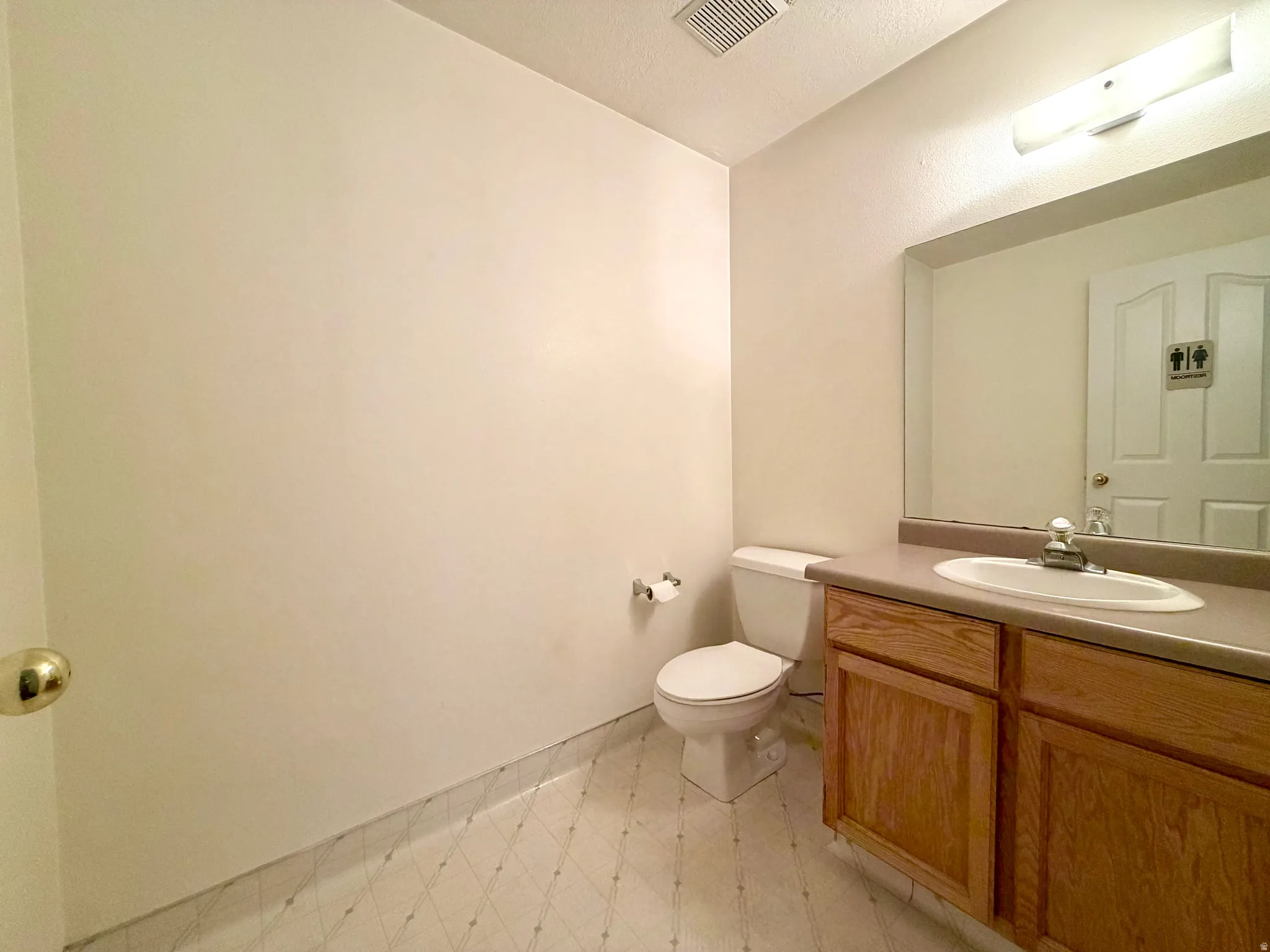 Bathroom featuring light flooring and vanity