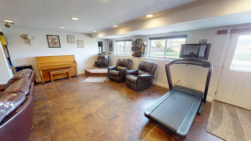 Exercise room featuring recessed lighting and a textured ceiling