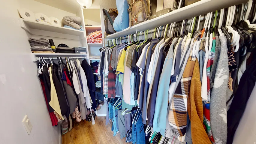 Primary Walk in closet featuring light wood finished floors