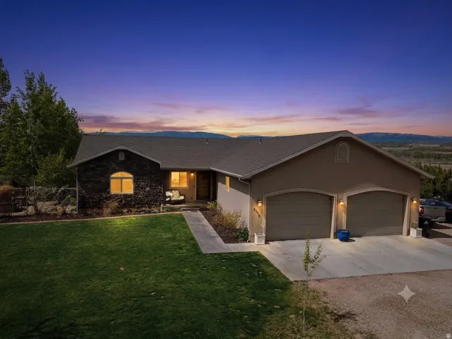 Ranch-style residence featuring a stone facade and stucco exterior