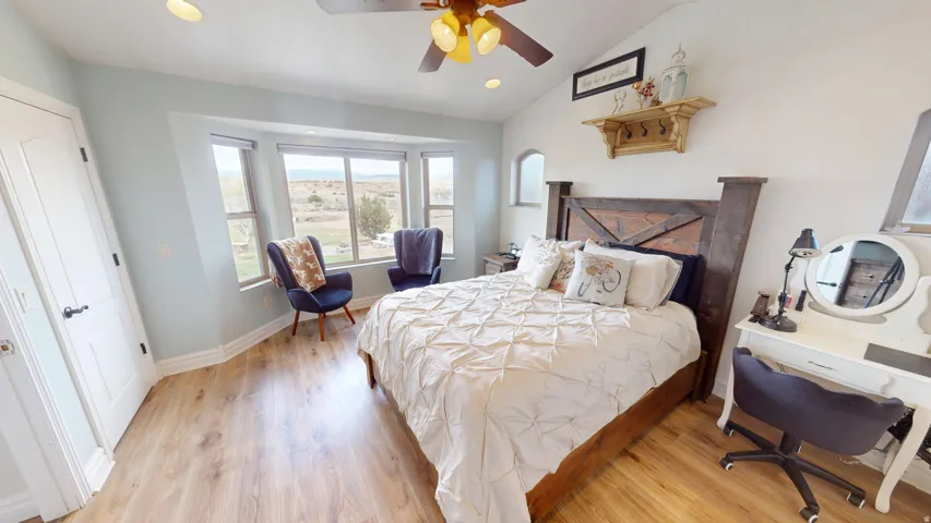 Primary Bedroom featuring recessed lighting, light wood-type flooring, vaulted ceiling, and ceiling fan