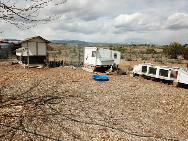 View of yard featuring exterior structure, an outbuilding, and a rural view