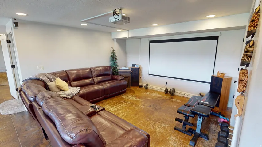 Home theater room featuring recessed lighting and a textured ceiling