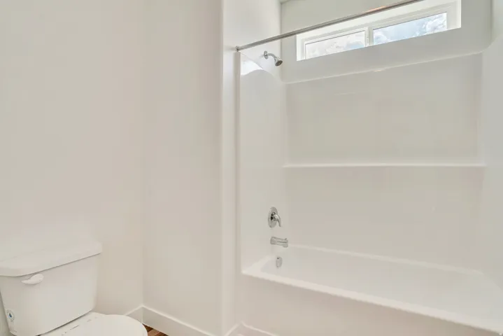 Bathroom featuring toilet and tub / shower combination