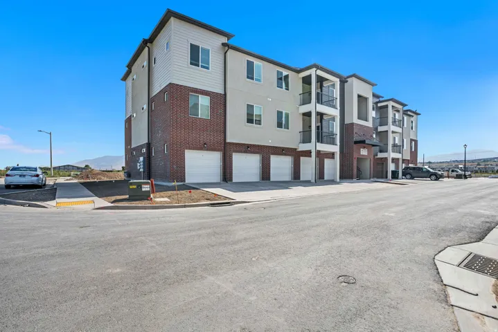 View of apartment building / complex featuring a garage
