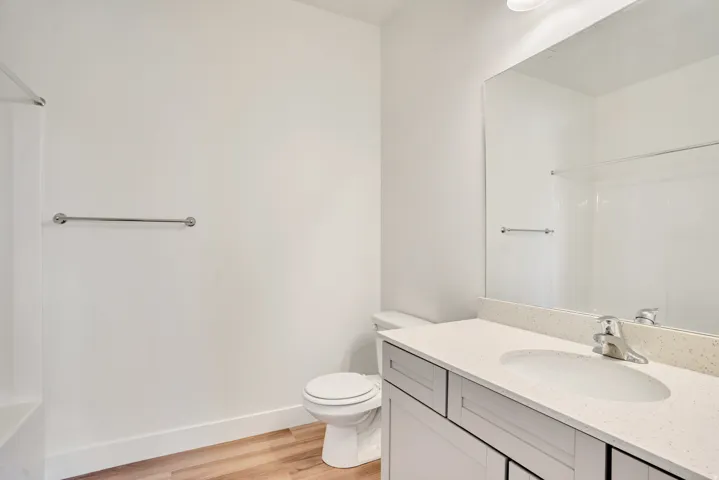 Full bath with vanity, light wood-style flooring, and shower / bathtub combination