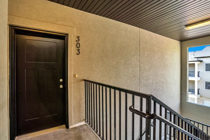 Property entrance with stucco siding