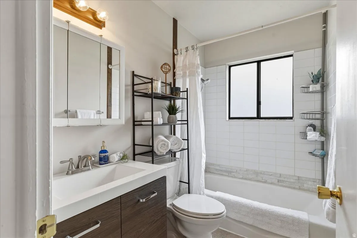 Full bathroom with vanity and shower / tub combo with curtain