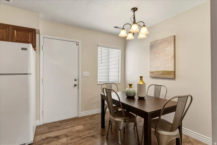 Dining area featuring suspended lighting and wood finished floors