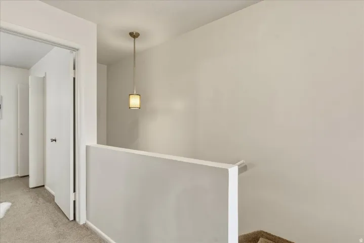 Hall with an upstairs landing and carpet floors