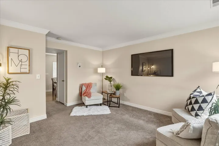 Sitting room featuring carpet and crown molding