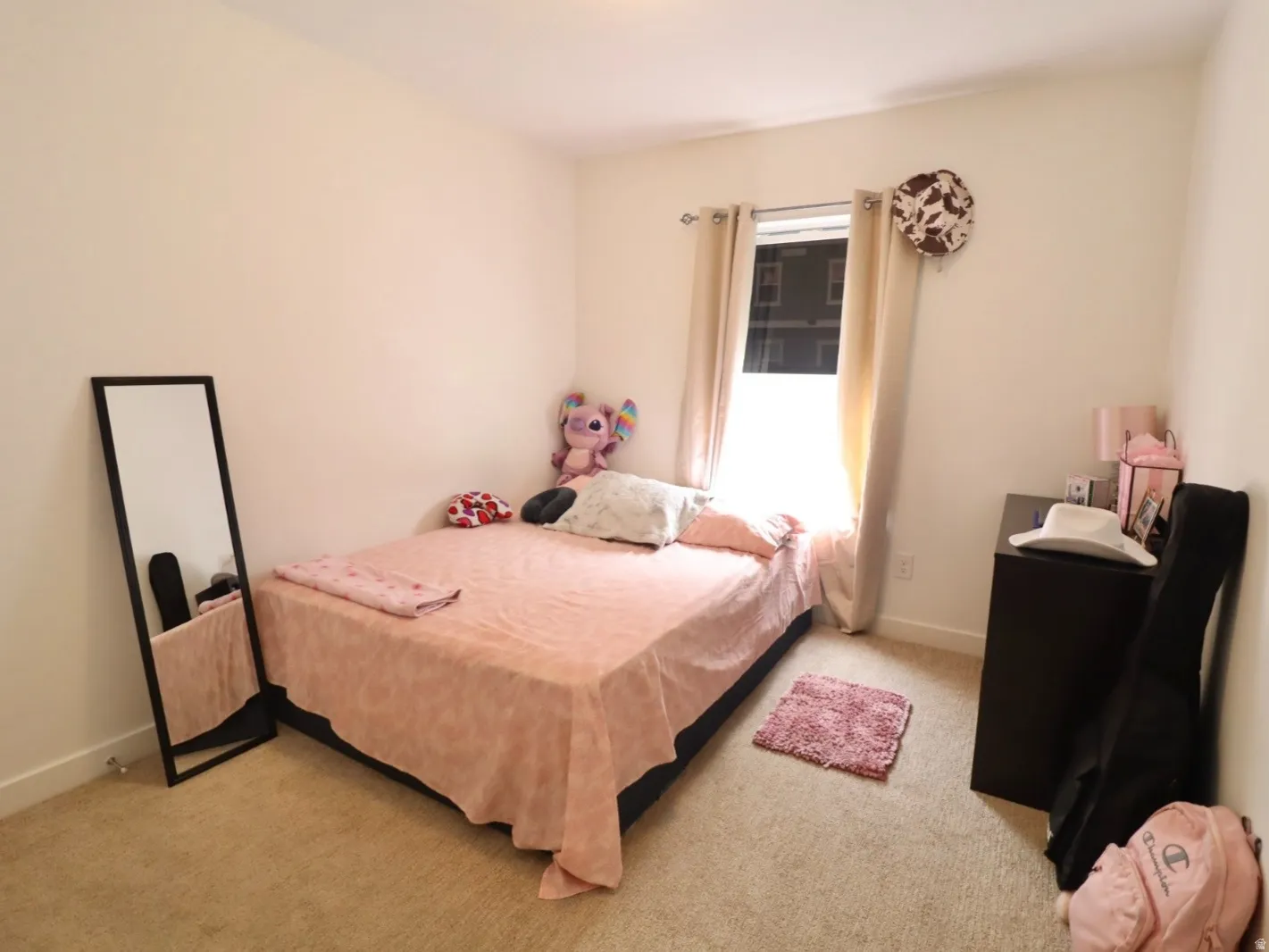 Bedroom with light colored carpet