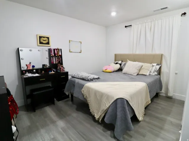 Bedroom featuring wood finished floors and baseboards