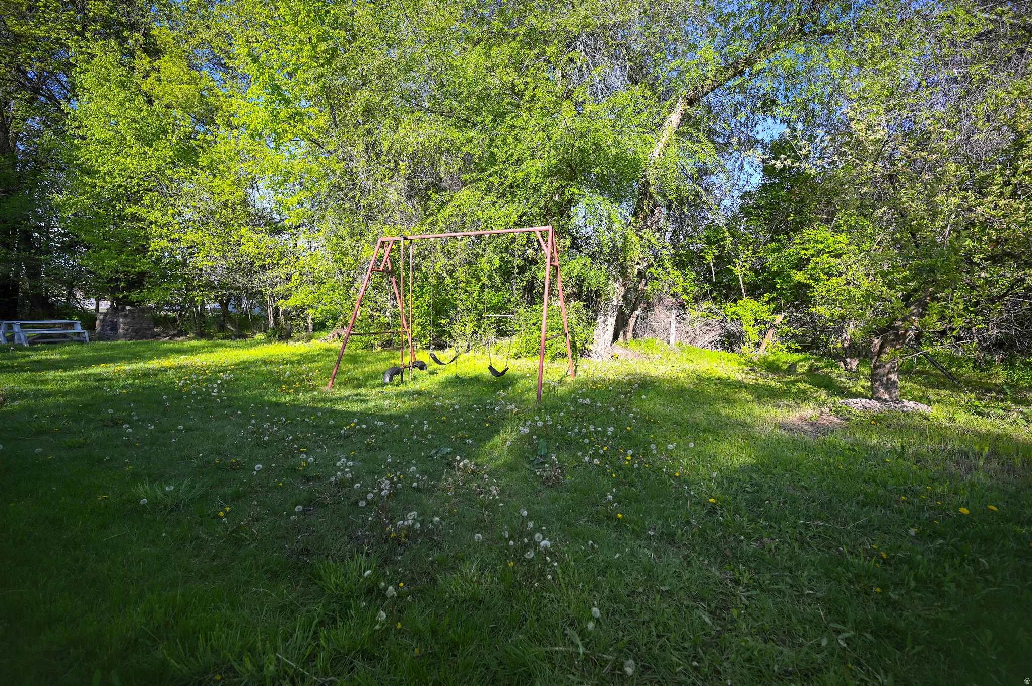 View of grassy yard featuring a playground