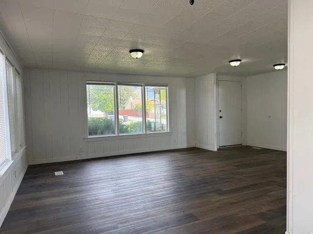 Spare room with dark wood-style floors